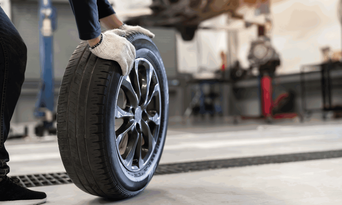 A tyre being rolled through a workshop