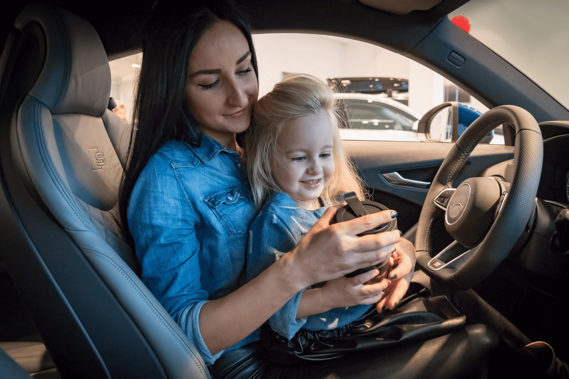 Lady with child sat inside an Audi