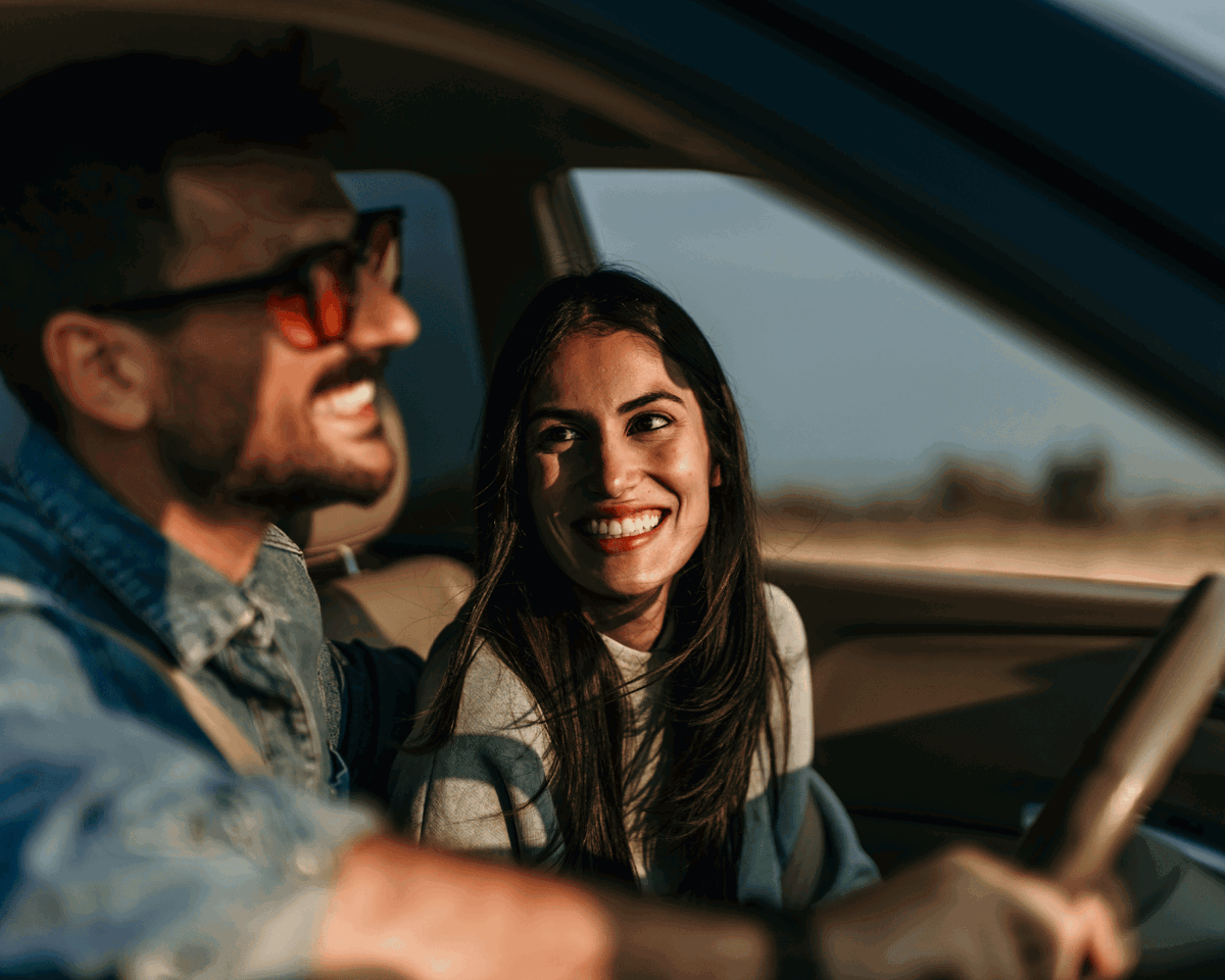 Woman smiling at man in a car