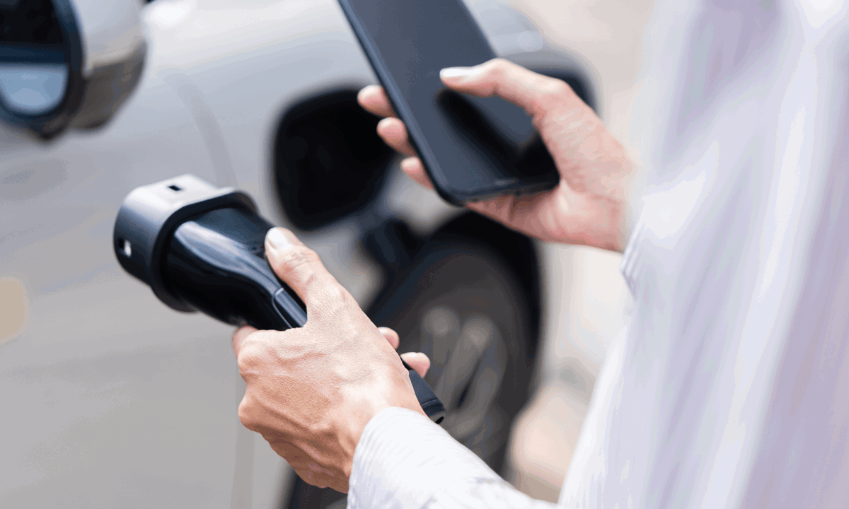 Lady holding phone and car charger.png